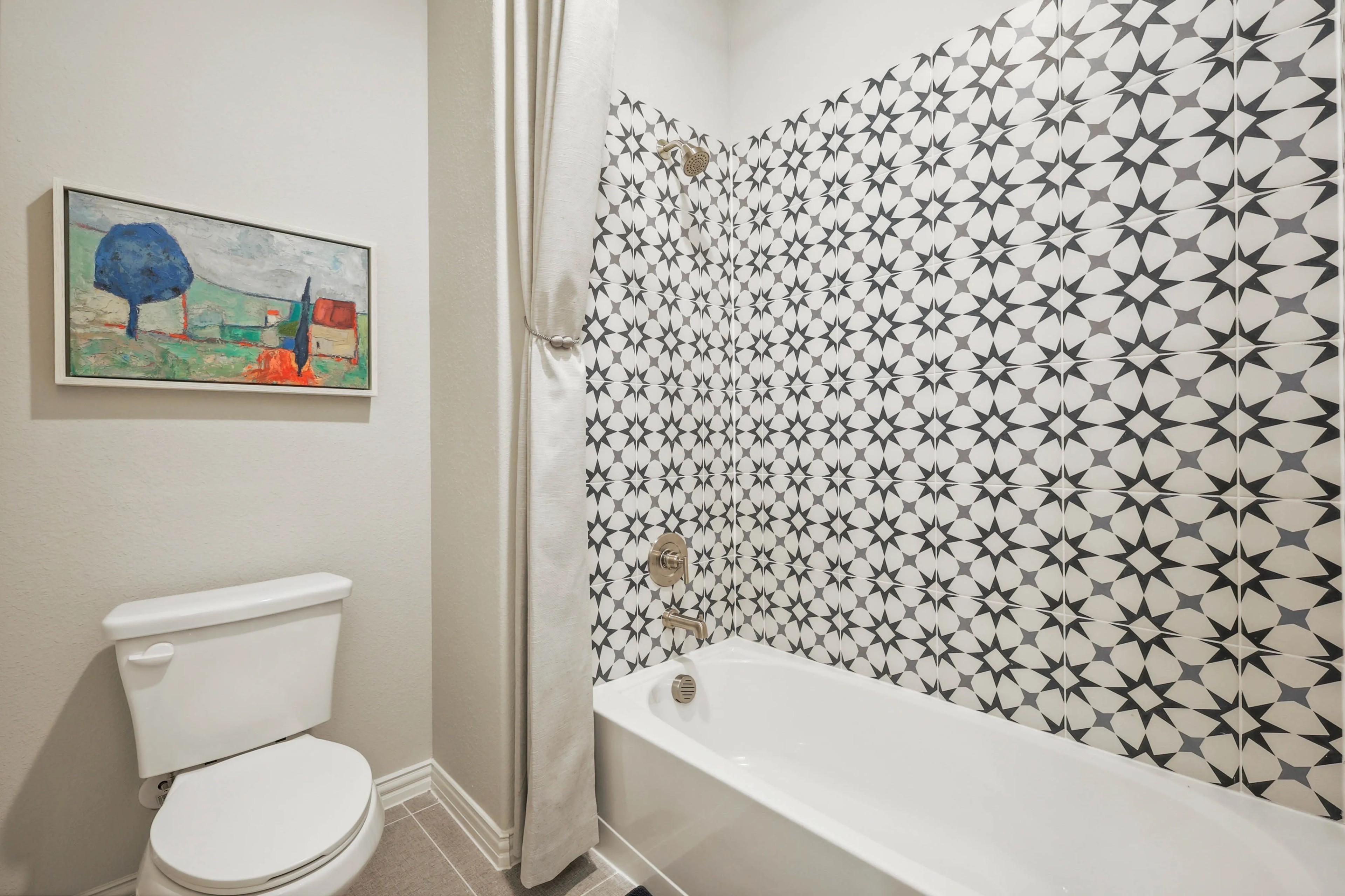 Pebblebrook Bathroom with Geometric Tile and Art Modern bathroom with geometric tile pattern and abstract art. Pebblebrook community.