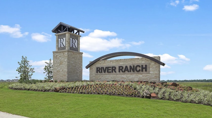 River Ranch Community Entrance Monument, Texas Landscape Stone monument with "River Ranch" sign, arched metal feature, landscaped garden, Texas community.
