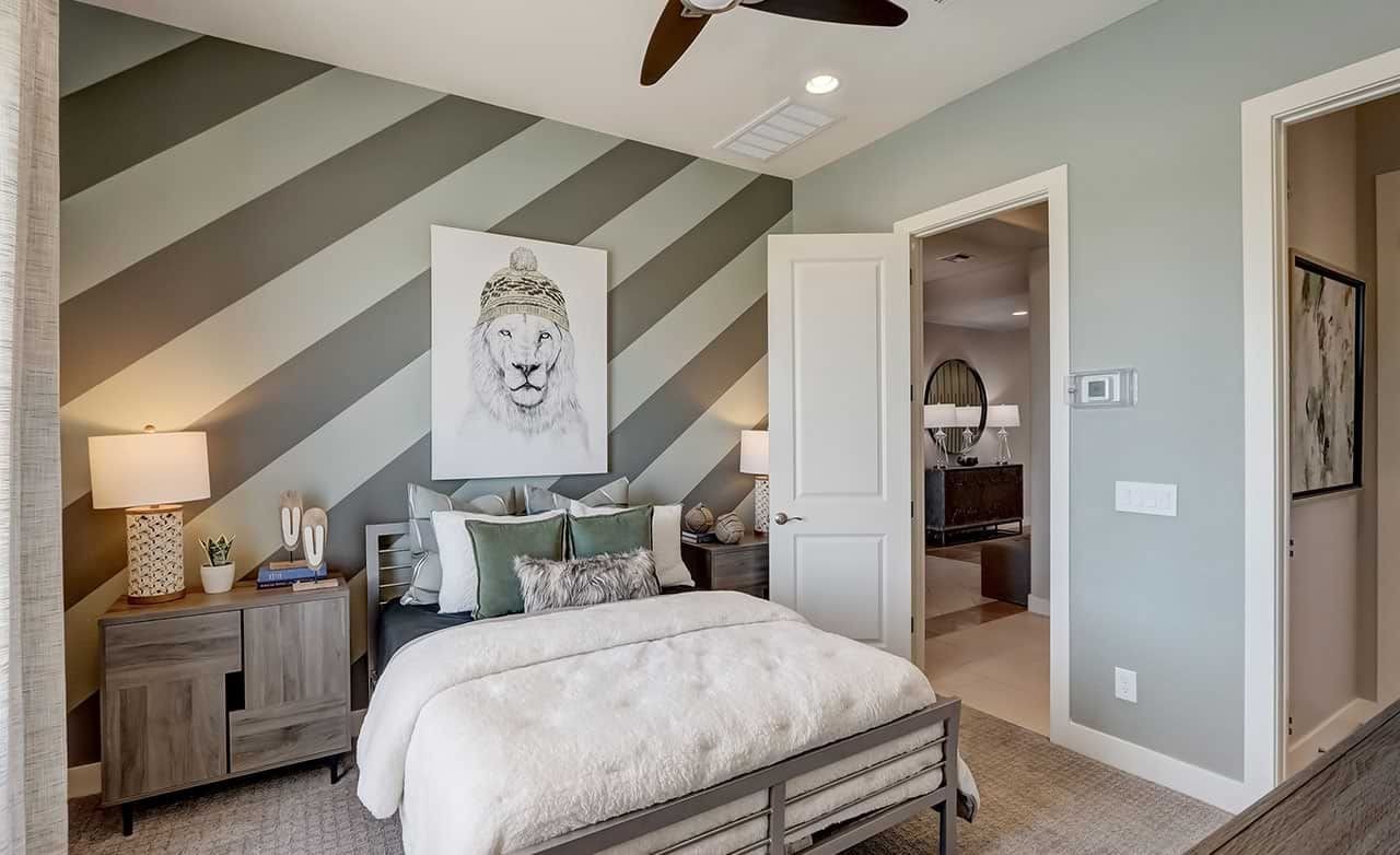 Luxurious Bedroom Design in Hacienda Community Home Elegant bedroom with diagonal striped wall, lion artwork, modern furniture in Hacienda community.