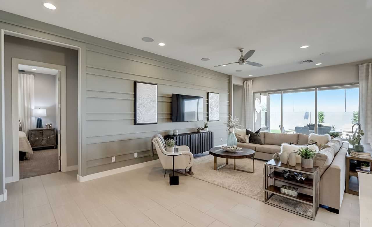 Luxurious Hacienda Living Room with Modern Decor and Canyon Views Luxurious living room in Hacienda community with sleek modern decor, large windows, and integrated entertainment unit.