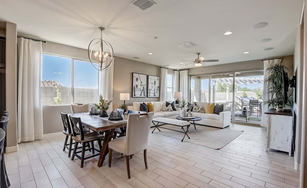 Elegant Open-Plan Living and Dining Room in Anderson Parc Luxurious open-plan living room with dining area, stylish lighting, and patio view in Anderson Parc home.
