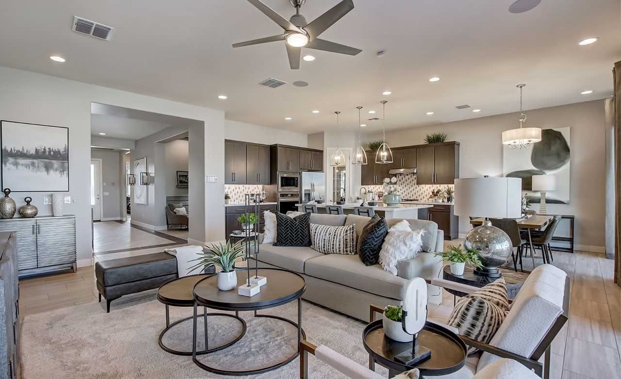 Elegant Open-Plan Living Room with Modern Kitchen at Mirada Crossing Luxury open-plan living space with modern kitchen, elegant lighting, and plush furnishings in Mirada Crossing.
