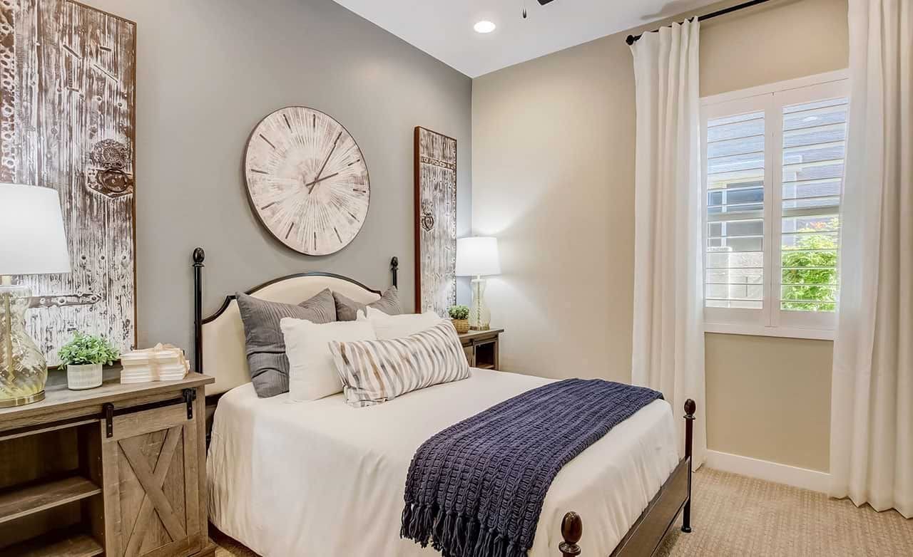 Mirada Crossing Bedroom with Rustic Decor and Large Clock Elegant bedroom with rustic decor, large clock, wood accents, Mirada Crossing luxury home. Neutral palette, natural light.