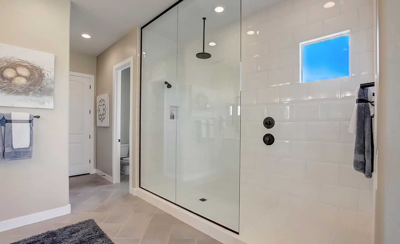 Elegant Shower Design with Modern Fixtures in Mirada Crossing Luxurious glass-enclosed shower with modern fixtures; elegant tile work; Mirada Crossing location.